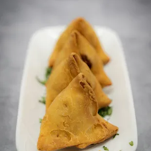 three fried pastries on a plate