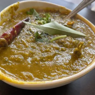 a bowl of curry with a spoon