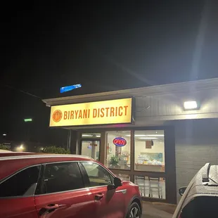 a car parked in front of a restaurant