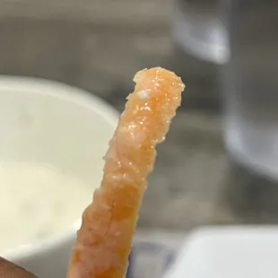 a person holding a piece of food