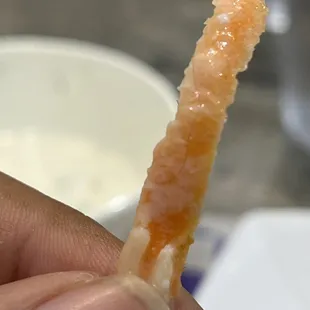 a person holding a piece of food