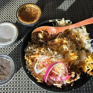 Hyderabadi goat dum biriyani with raita and a complimentary dessert.