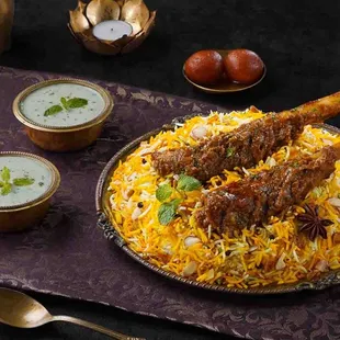 a plate of biryanii and bowls of soup