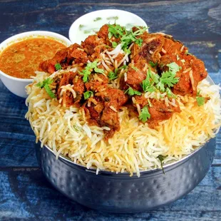 a bowl of rice with meat and sauce