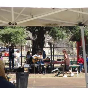 a group of people sitting under a tent