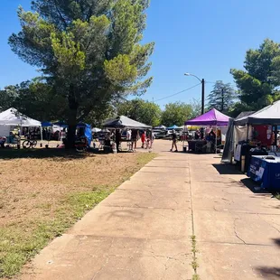 a sidewalk lined with tents