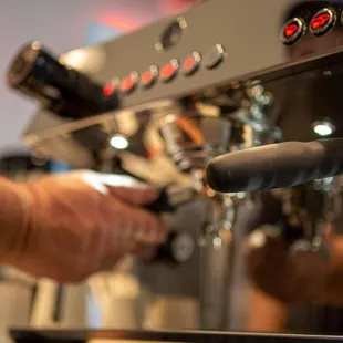 a person using a coffee machine