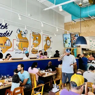 people sitting at tables in a restaurant