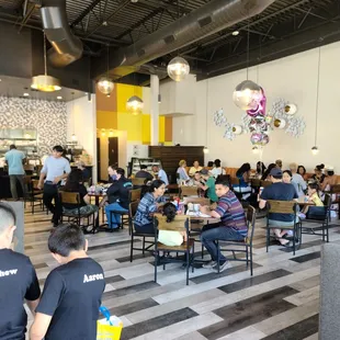 people sitting at tables in a restaurant