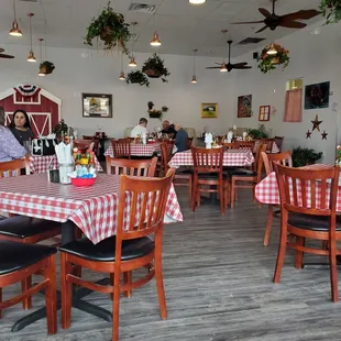 a dining area with tables and chairs