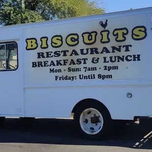 a white food truck parked in a parking lot