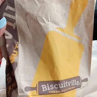 a person holding a bag of biscuits