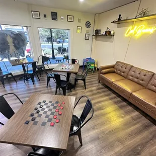 Casual bar setting for games, reading, and orders.