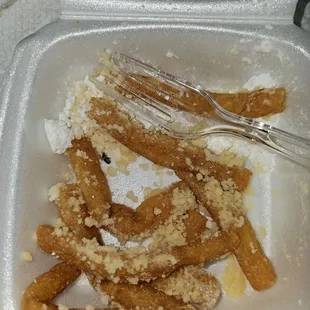 Funnel fries with a fly as garnishment