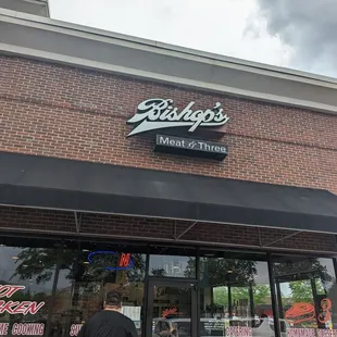 a man walking in front of a restaurant