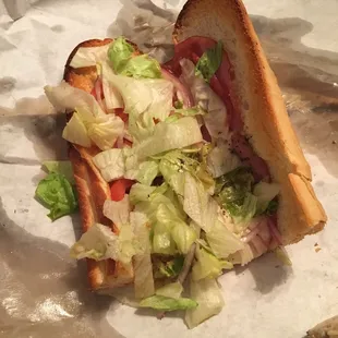 a sandwich with lettuce and tomato