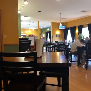 people sitting at tables in a restaurant