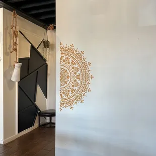 a white wall with a decorative design on it