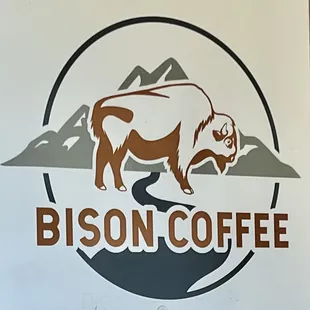 a bison in a circle with mountains in the background