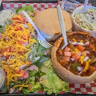 Chef salad, chili in bread bowl and cole slaw.