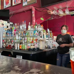 a woman behind the bar