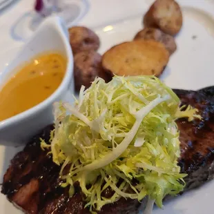 12oz Prime Angus New York Steak with green peppercorn sauce.  So very good.