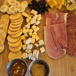 a variety of meat and cheeses on a cutting board