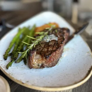 a plate of steak and asparagus