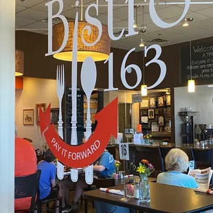 people sitting at tables in a restaurant