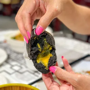 egg yolk lava steamed squid ink bun