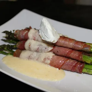 Prosciutto wrapped Asparagus topped with a dollap of goat cheese and a lemon garlic goat cheese glaze