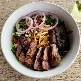 a bowl of food with meat and vegetables