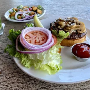 a burger and salad on a plate