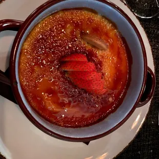 a bowl of soup with a strawberry in it
