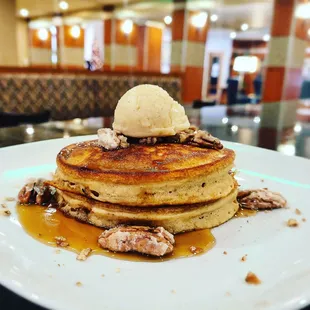 a stack of pancakes with ice cream and walnuts