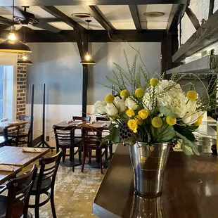 a vase of flowers on a table in a restaurant