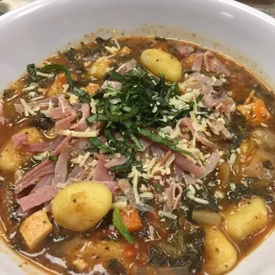 a bowl of soup with meat and vegetables