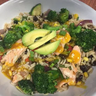 a bowl of rice, broccoli, and avocado