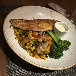 a plate of fish and vegetables