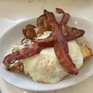 Biscuits and gravy with eggs and bacon