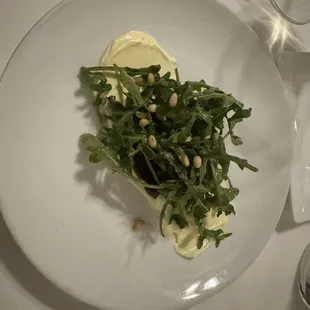 Roasted Beets with baby arugula, ginger chèvre, and harissa-orange vinaigrette and pine nuts.