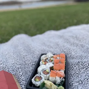 a plate of sushi on a blanket