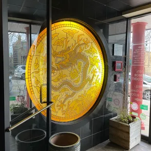 a circular window with a yellow dragon on it