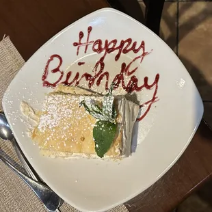 a plate of food with a happy birthday written on it