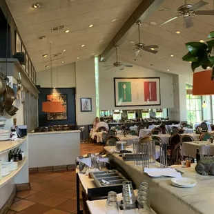 a dining area with tables and chairs