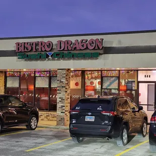 cars parked in front of a restaurant