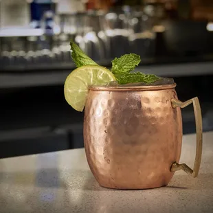 a copper mug with a lime garnish