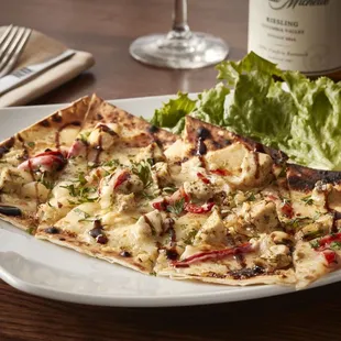 a plate of food and a bottle of wine