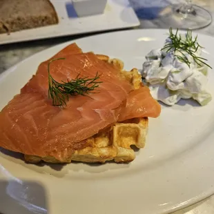 Smoked salmon waffle appetizer. Tip - spread the creamy cucumber directly on the waffle before eating, otherwise it's quite dry.