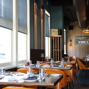 an empty restaurant with orange chairs